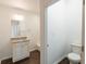 Bathroom with granite vanity, white cabinets, toilet, and tub/shower combo at 1210 Churchman Ave, Indianapolis, IN 46203