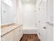 Bathroom featuring vanity with granite countertop, tub, tiled shower, and wood floor at 1210 Churchman Ave, Indianapolis, IN 46203