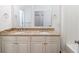 Bright bathroom featuring double sinks with granite countertop and white cabinetry at 1210 Churchman Ave, Indianapolis, IN 46203