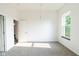 Bedroom featuring neutral carpet, natural light from a bright window, and closet access at 1210 Churchman Ave, Indianapolis, IN 46203