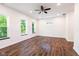 Spacious bedroom with natural light from large windows and dark wood floors at 1210 Churchman Ave, Indianapolis, IN 46203