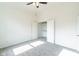 Sunlit bedroom boasts neutral carpet, ceiling fan and a spacious closet with ample storage at 1210 Churchman Ave, Indianapolis, IN 46203