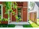 Inviting front entrance with a modern glass door, decorative sconces, and clear address numbers on a well-maintained facade at 1210 Churchman Ave, Indianapolis, IN 46203