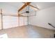 A clean and spacious garage featuring high ceilings, exposed beams, and a concrete floor at 1210 Churchman Ave, Indianapolis, IN 46203