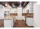 Open kitchen features stainless appliances, granite counters, and a functional island with sink at 1210 Churchman Ave, Indianapolis, IN 46203