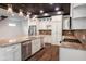 Modern kitchen boasts stainless appliances, granite counters and island, with view to pantry at 1210 Churchman Ave, Indianapolis, IN 46203
