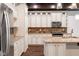 Well-equipped kitchen features stainless appliances, granite counters, and ample white cabinetry at 1210 Churchman Ave, Indianapolis, IN 46203