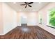 Open living room with ceiling fan, dark wood floors, and lots of natural light at 1210 Churchman Ave, Indianapolis, IN 46203