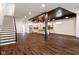 Spacious living room featuring modern staircase and a gourmet kitchen with stainless steel appliances at 1210 Churchman Ave, Indianapolis, IN 46203