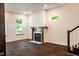 Cozy living room features a modern fireplace, wood floors, and large bright windows at 1210 Churchman Ave, Indianapolis, IN 46203