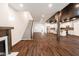Open concept living room boasts wood floors, modern kitchen, fireplace and staircase at 1210 Churchman Ave, Indianapolis, IN 46203