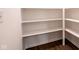 Walk-in pantry with white shelves and convenient electrical outlets at 1210 Churchman Ave, Indianapolis, IN 46203