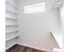 Clean walk-in closet with built-in shelves, ample storage, and a window for natural light at 1210 Churchman Ave, Indianapolis, IN 46203