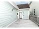 A spacious back porch of a light-blue home with a door that leads inside at 1221 Cottage Ave, Indianapolis, IN 46203
