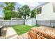 Backyard showcasing a lush green lawn, shed, wooden fence, deck, patio and picnic table at 1221 Cottage Ave, Indianapolis, IN 46203
