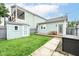 Backyard featuring a manicured lawn, shed, wooden deck with picnic table, and access to the house at 1221 Cottage Ave, Indianapolis, IN 46203