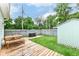 Backyard features wooden deck, picnic table, lush green lawn, shed, and a privacy fence at 1221 Cottage Ave, Indianapolis, IN 46203