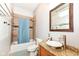 Bathroom featuring a granite countertop vanity, wood-trimmed mirror, and shower and tub combination at 1221 Cottage Ave, Indianapolis, IN 46203