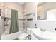 Modern bathroom with tile shower, decorative accents, and ample storage at 1221 Cottage Ave, Indianapolis, IN 46203