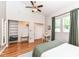 Sunlit bedroom featuring a ceiling fan, hardwood floors, ensuite closet and an abundance of natural light at 1221 Cottage Ave, Indianapolis, IN 46203