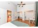 Bright bedroom features wood floors, ceiling fan, and ensuite closet, plus a view into the kitchen at 1221 Cottage Ave, Indianapolis, IN 46203