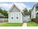 Charming home featuring light-blue wood siding, a front porch, and a well-maintained lawn at 1221 Cottage Ave, Indianapolis, IN 46203