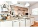 This kitchen features granite countertops, white cabinets, and stainless steel sink at 1221 Cottage Ave, Indianapolis, IN 46203