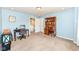 Bright bedroom with two desks, blue walls, carpet flooring, and access to the hallway at 1314 Old Heritage Pl, Greenwood, IN 46143