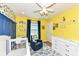 Bright Bedroom with lemon wallpaper, a white crib, a blue armchair, and a changing table at 1314 Old Heritage Pl, Greenwood, IN 46143