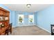 Serene bedroom with soft blue walls, carpet flooring, and a desk for focused work or study at 1314 Old Heritage Pl, Greenwood, IN 46143
