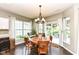 Cozy dining area featuring a wooden table set, large windows with natural light, and sliding glass door leading to patio at 1314 Old Heritage Pl, Greenwood, IN 46143