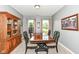 Formal dining room featuring a large wooden table set, a decorative hutch, patterned curtains, and neutral walls at 1314 Old Heritage Pl, Greenwood, IN 46143