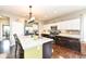 Spacious kitchen with granite countertops, a center island, stainless appliances, and tile backsplash that add elegance at 1314 Old Heritage Pl, Greenwood, IN 46143