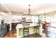 Modern kitchen with stainless steel appliances, a center island with seating, and a view of the adjacent dining area at 1314 Old Heritage Pl, Greenwood, IN 46143