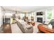 Open-concept living room featuring a fireplace, hardwood floors, and adjacent kitchen at 1314 Old Heritage Pl, Greenwood, IN 46143