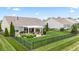 A backyard features a black metal fence, lush lawn, patio with pergola offering an outdoor living space at 13327 Hockley Dr, Fishers, IN 46037