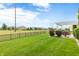 Large, well-manicured backyard with black fence, patio with pergola, and lush landscaping at 13327 Hockley Dr, Fishers, IN 46037
