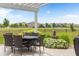 Serene backyard patio with dining table and chairs, lush greenery, and a charming water feature at 13327 Hockley Dr, Fishers, IN 46037