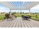 Relaxing backyard patio featuring comfortable seating, dining area, and a white pergola at 13327 Hockley Dr, Fishers, IN 46037