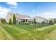 A well-manicured lawn with a black metal fence and a pergola-covered patio creates a private backyard oasis at 13327 Hockley Dr, Fishers, IN 46037