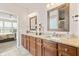 Bathroom featuring double sinks, granite countertops, and wooden cabinets at 13327 Hockley Dr, Fishers, IN 46037