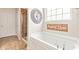 Bathroom boasts a soaking tub and separate shower, complete with decorative wall art and a large window at 13327 Hockley Dr, Fishers, IN 46037