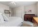 Carpeted bedroom is furnished with a bed, writing desk, and closet at 13327 Hockley Dr, Fishers, IN 46037