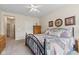 Cozy bedroom with carpet flooring, ceiling fan, and a dresser at 13327 Hockley Dr, Fishers, IN 46037