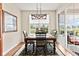 Light-filled dining room with backyard view, light fixture, and wood floors at 13327 Hockley Dr, Fishers, IN 46037