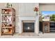 Elegant fireplace with tiled hearth, flanked by built-in shelving and media cabinet at 13327 Hockley Dr, Fishers, IN 46037