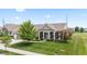 Welcoming home featuring a manicured lawn, mature shade trees, and covered porch with stately columns at 13327 Hockley Dr, Fishers, IN 46037
