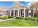 Inviting front porch with brick accents, decorative columns, and landscaped garden, offering a cozy welcome at 13327 Hockley Dr, Fishers, IN 46037