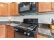 Close-up of a kitchen with stainless steel oven, microwave and granite countertops at 13327 Hockley Dr, Fishers, IN 46037