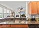 Open kitchen with granite countertops and stainless steel sink overlooks the living area with fireplace at 13327 Hockley Dr, Fishers, IN 46037